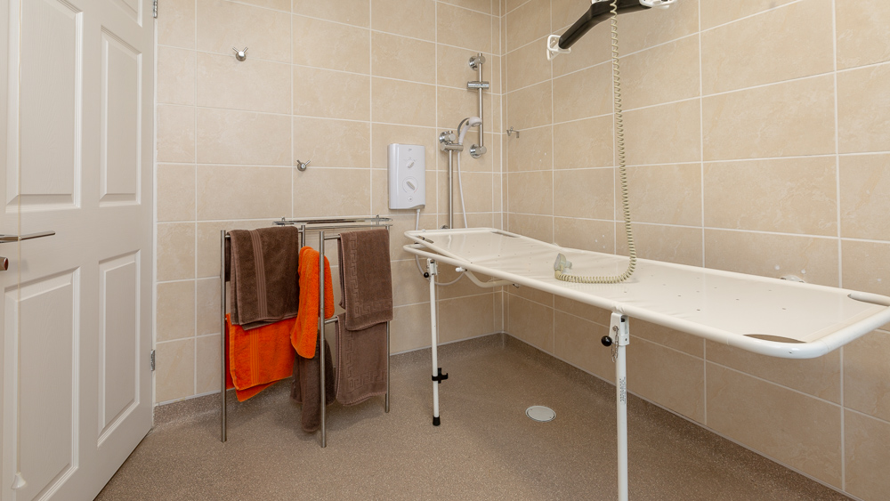 Accessible Wet Room with drop down changing stretcher and lots of room to transfer